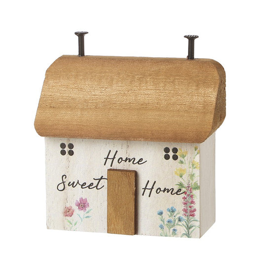Decorative birdhouse with 'Home sweet home' text and floral designs on a white background