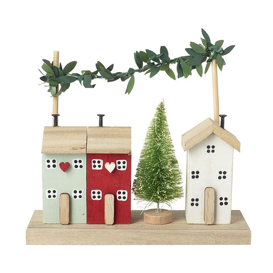 Decorative arrangement with wooden houses and a small tree on a white background