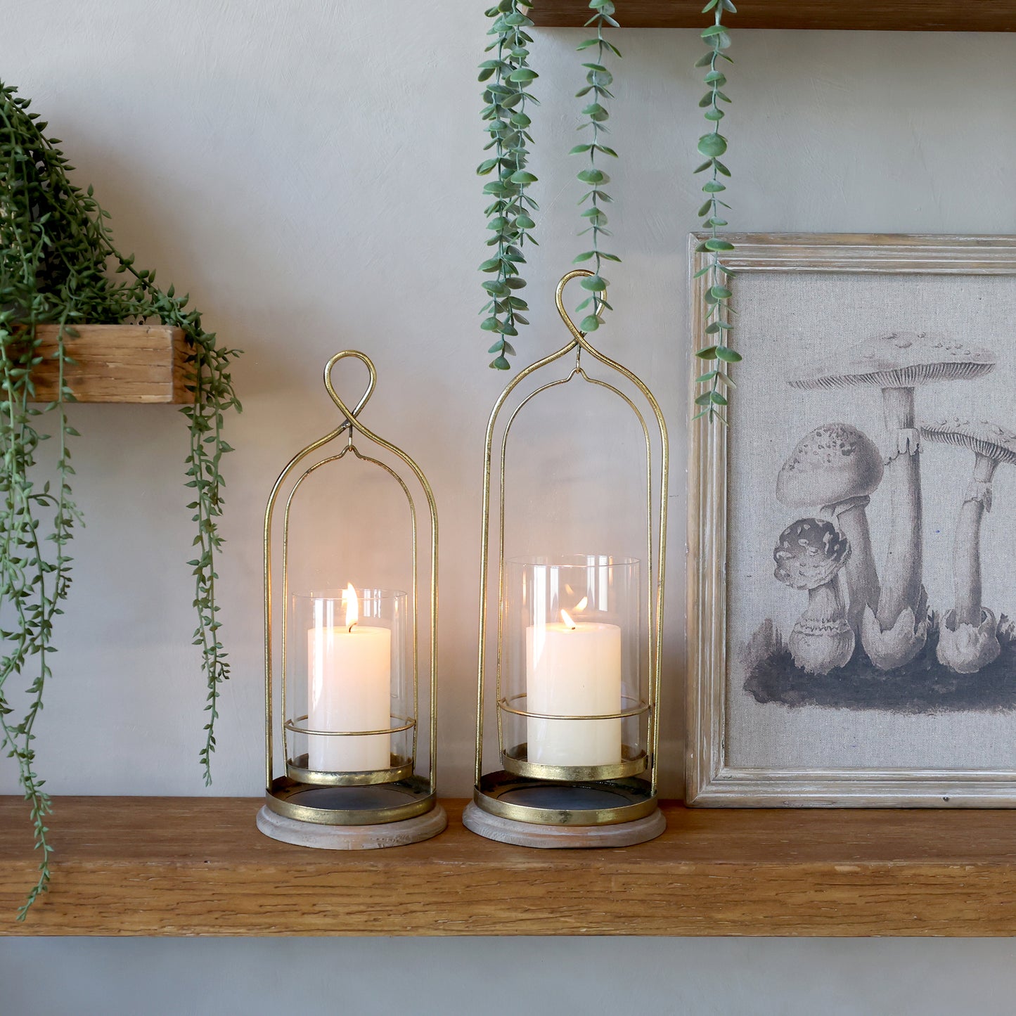 Two metal and glass hurricane lamps