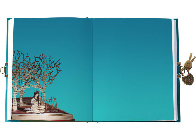 Open book with a decorative scene of a woman by a tree on a blue background