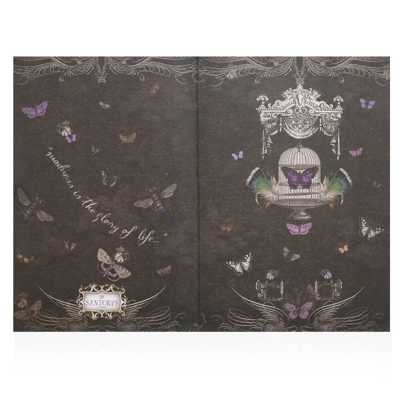 Decorative notebook with butterfly and birdcage design on a dark background