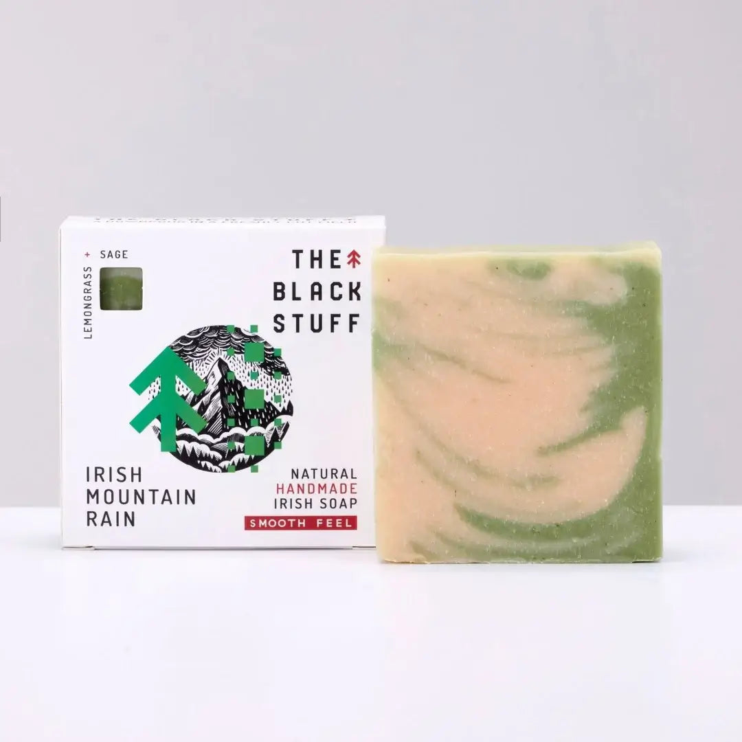 Packaging for 'The Black Stuff' Irish Mountain Rain bar soap, featuring the product name, a small amount of soap, and a rough feel description.