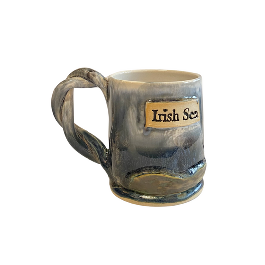 Hand thrown stneware mug with Irish Sea Shipping news messages embossed on the finish. Twisted handle
