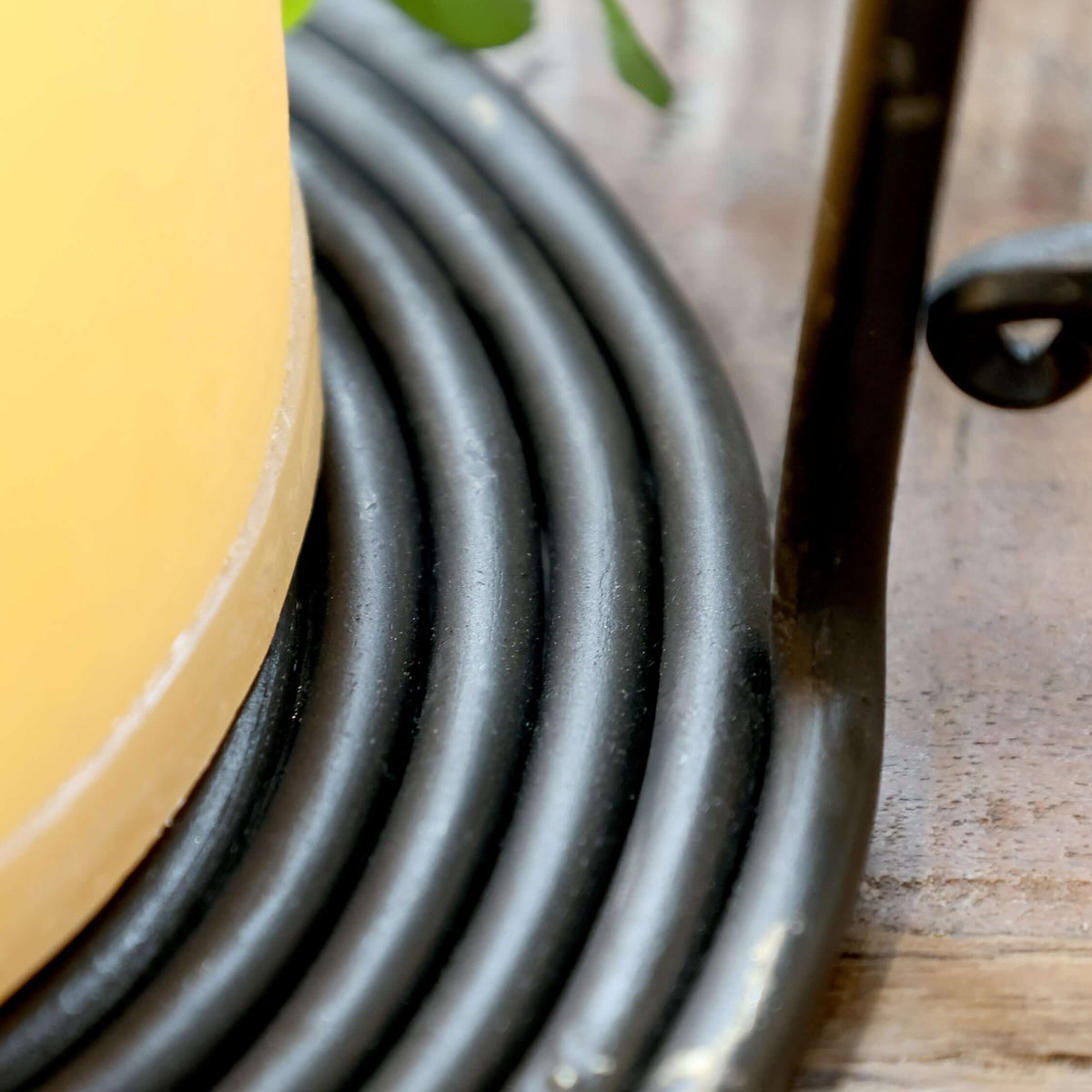 Close-up of a black coiled metal candle holder 