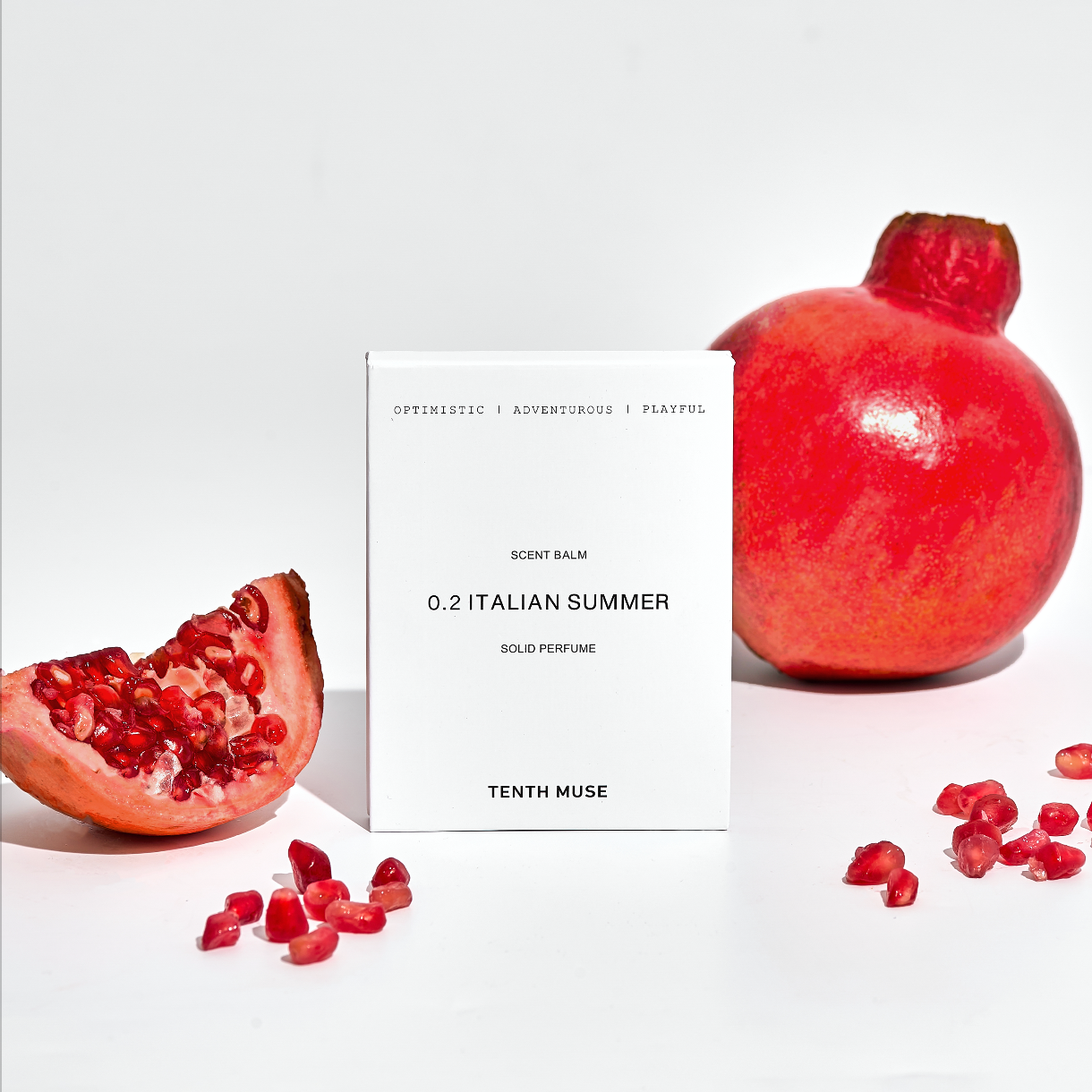 Pomegranate fruit and a box labeled 'Tenth Muse' on a white background
