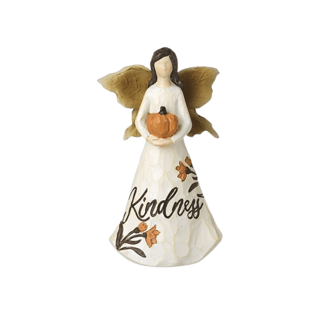 Angel figurine with 'Kindness' on its dress holding a pumpkin against a white background
