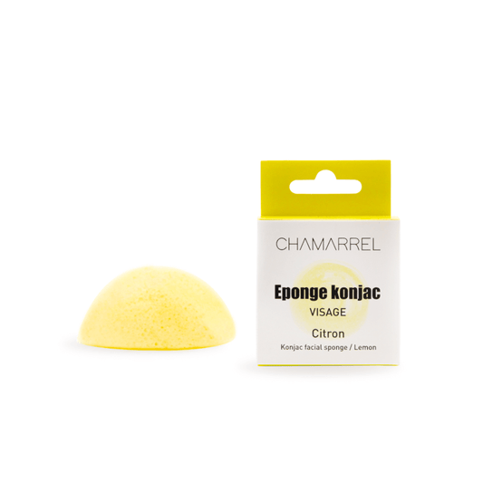 A yellow Konjac face sponge next to its packaging, labeled as 'Eponge konjac visage Citron'.