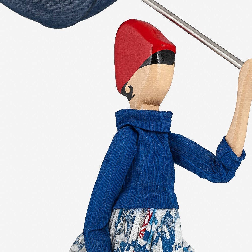 Lady lamp wearing a blue sweater and red hat on a white background
