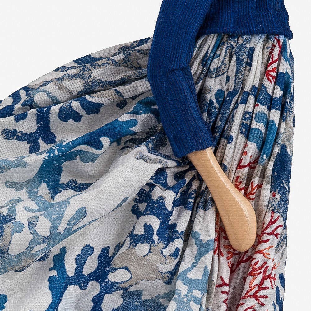 Close up of lady Lamp wearing a blue sweater and patterned skirt 