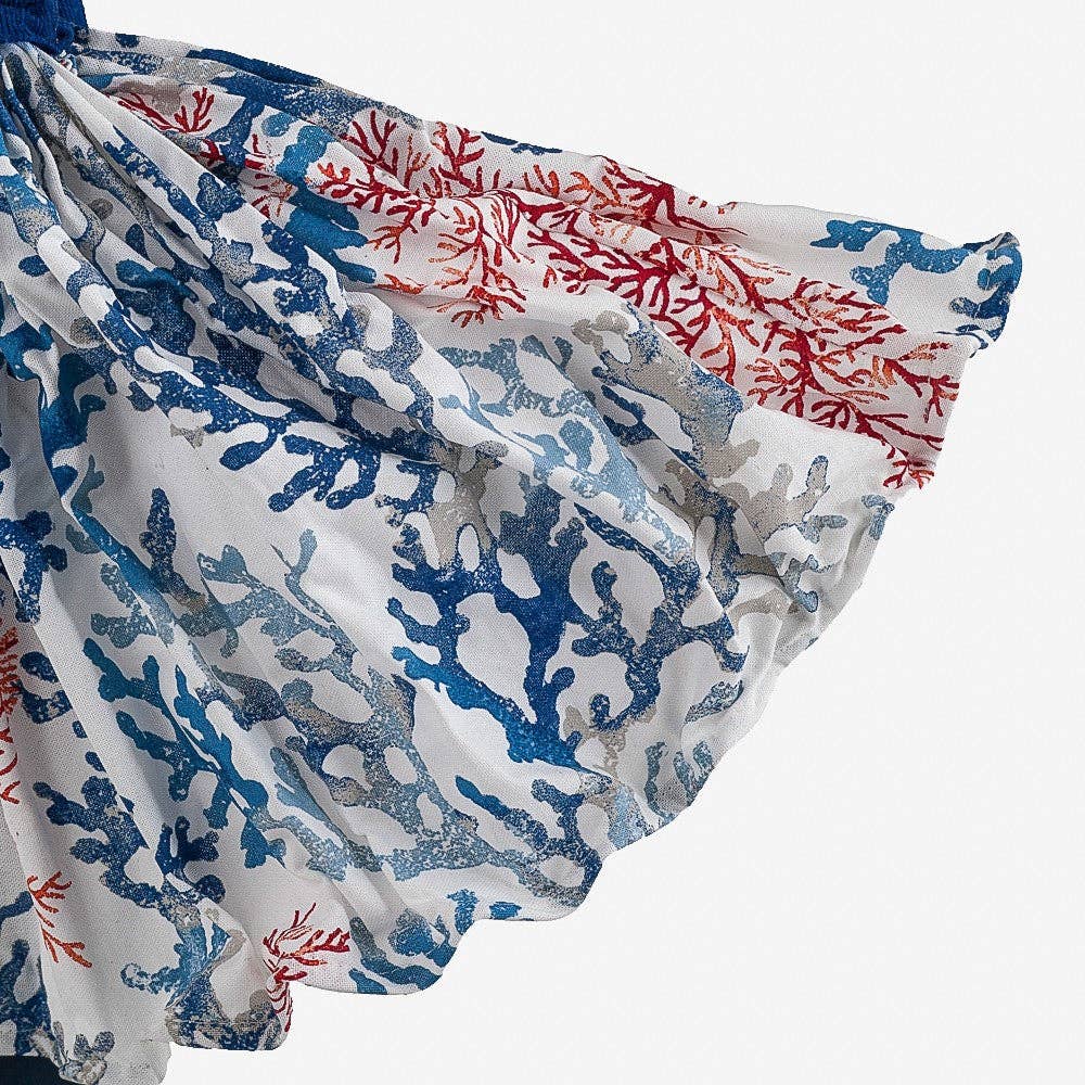 Coral patterned fabric with blue, red, and white colors on a white background