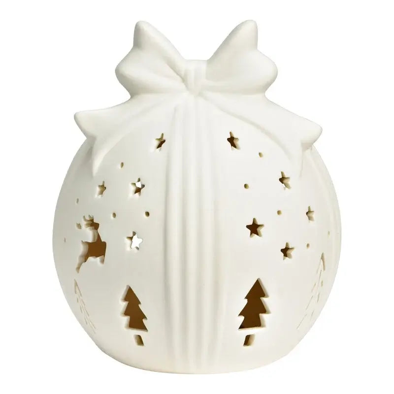 White ceramic ball with cut-out Christmas designs on a white background