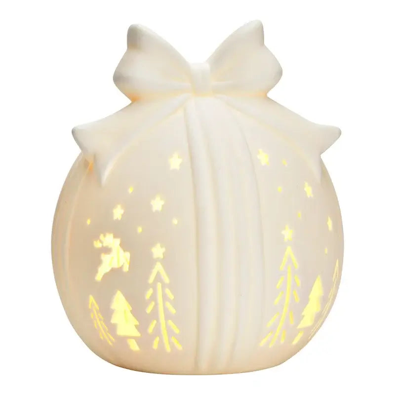 Decorative night light with tree and deer patterns on a white background