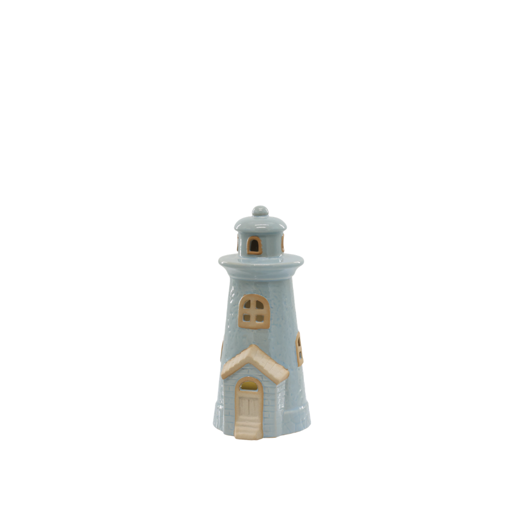 Small ceramic lighthouse figurine on a white background