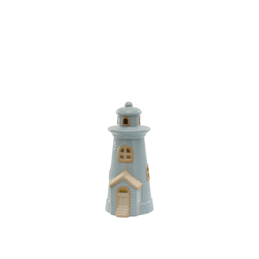 Small ceramic lighthouse figurine on a white background