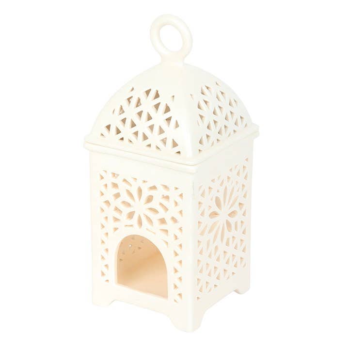 White decorative lantern with intricate cut-out patterns on a white background