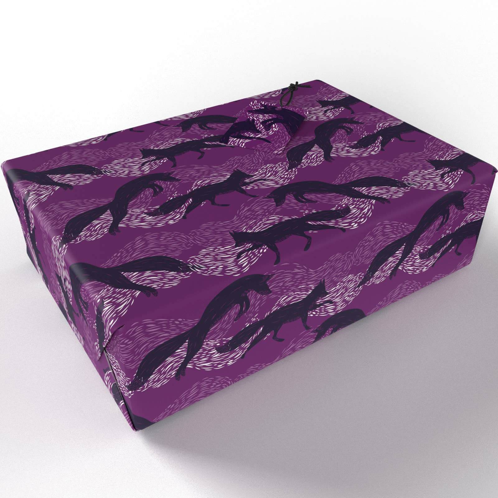 Leaping Foxes Wrapping Paper wrapped around a parcel on a white background