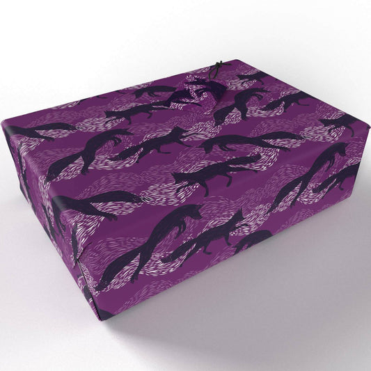 Leaping Foxes Wrapping Paper wrapped around a parcel on a white background