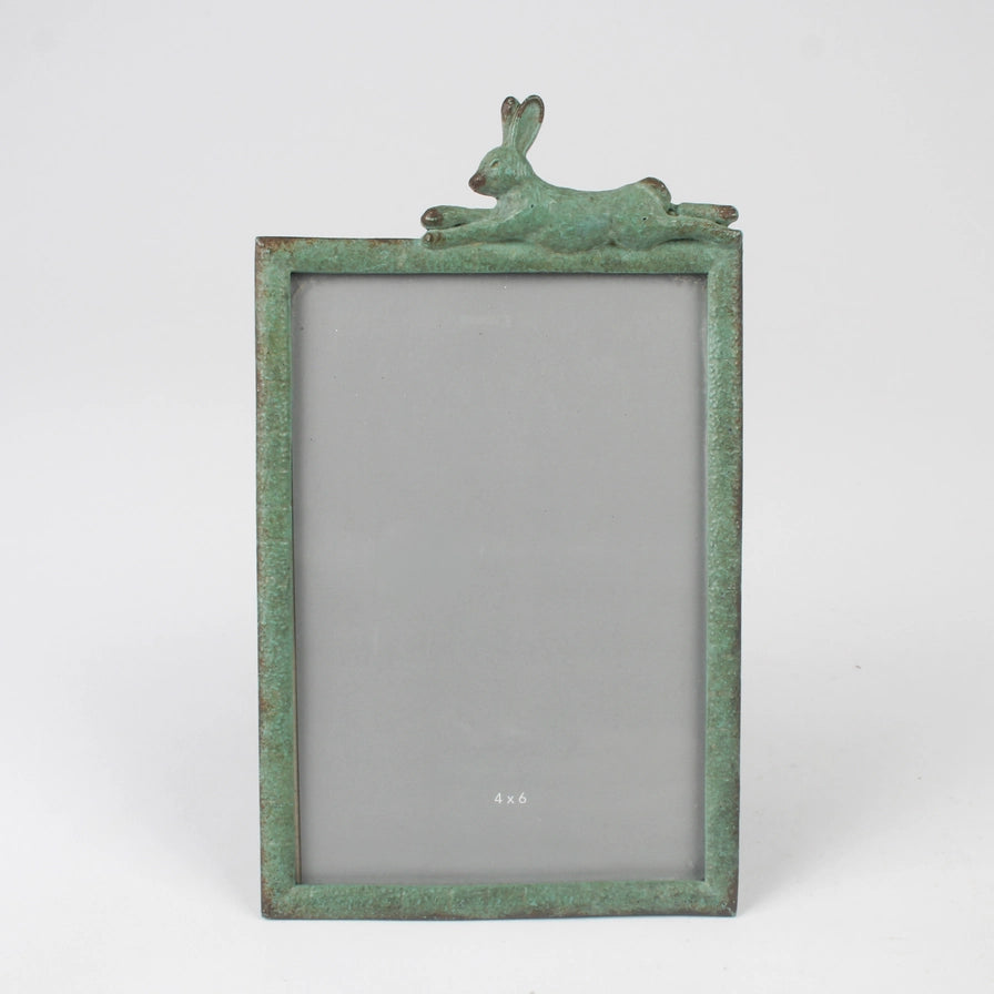 Green metal photo frame with a rabbit design on a white background