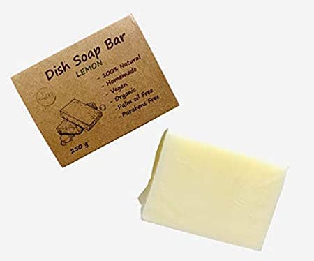 Lemon scented Eco Dish Soap Bar on a white background beside its packaging