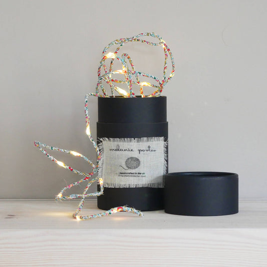 Liberty Print Fairy Light String: Eloise. String of fabric covered fairy lights in a black cylinder container