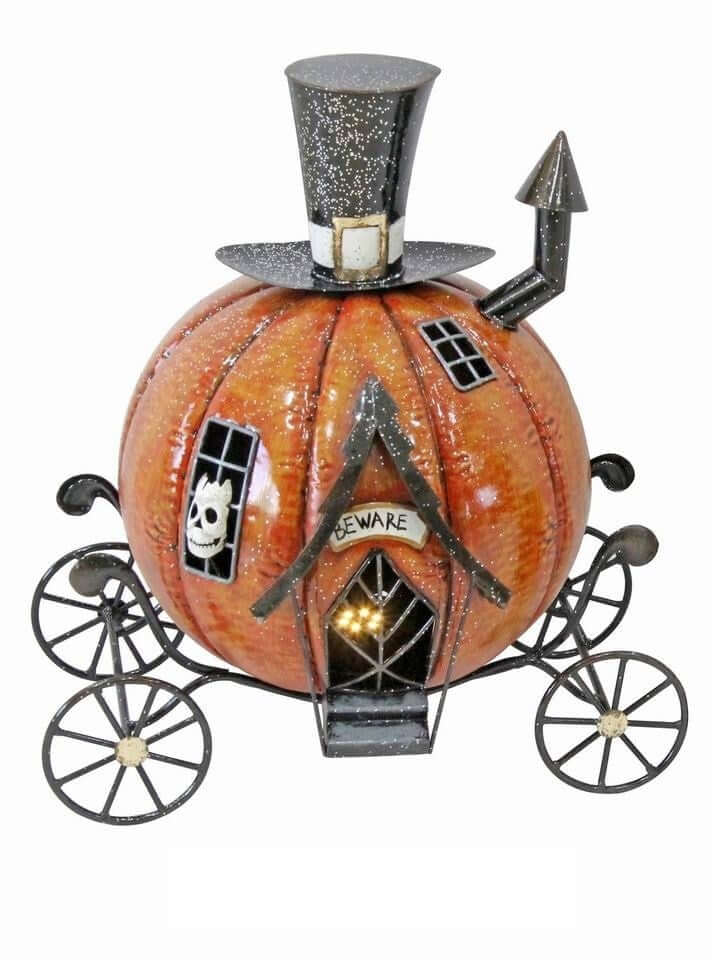 Decorative pumpkin with carriage wheels, top hat, and 'Beware' sign on a white background