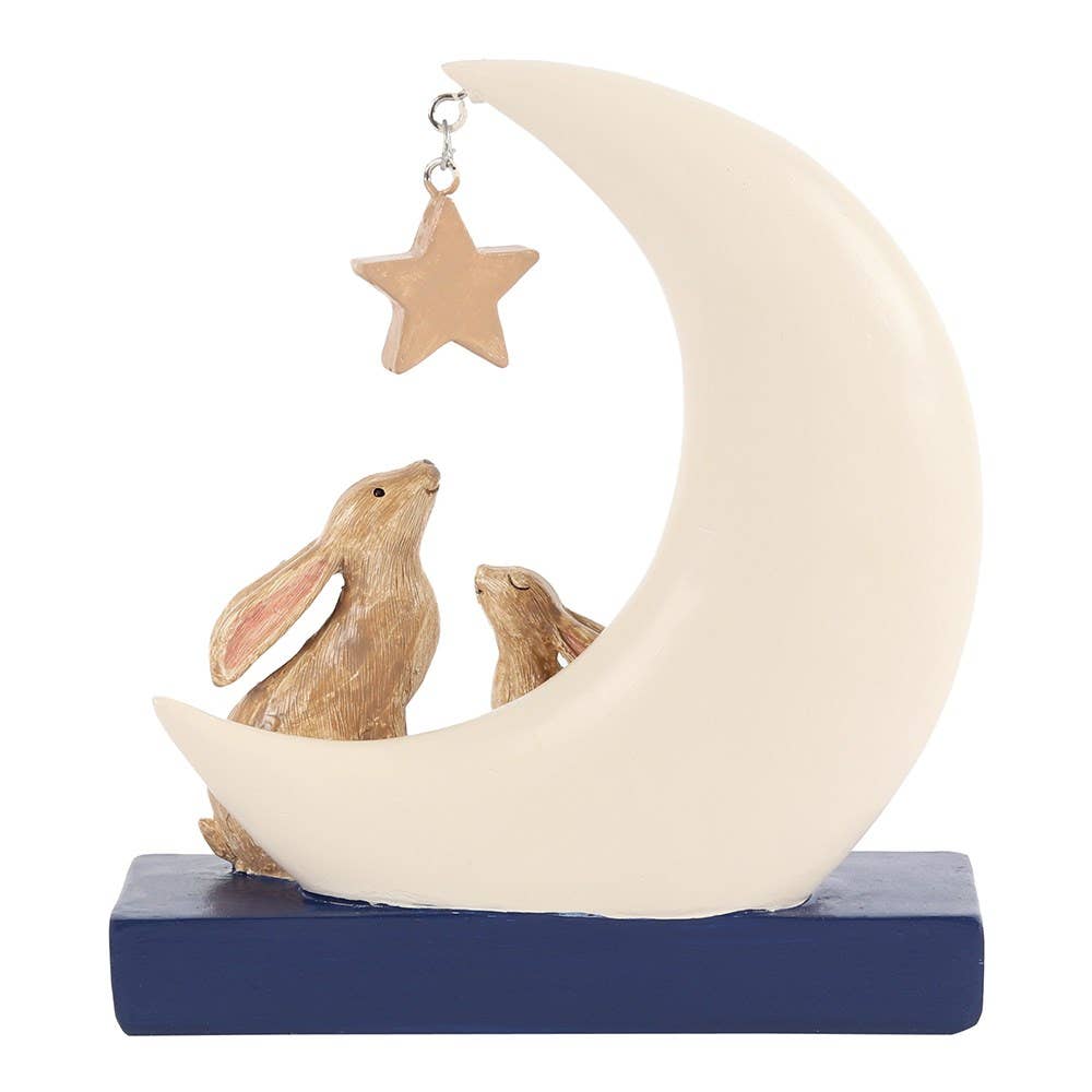 Decorative figurine of two rabbits on a moon with a star above, on a blue base.