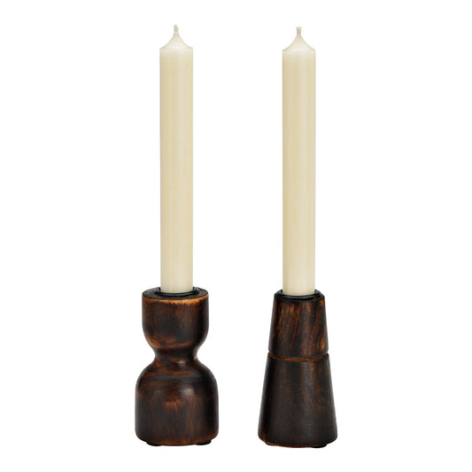 Two wooden candle holders with white candles on a white background