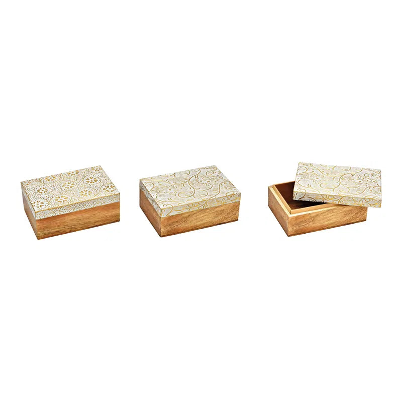 Set of four wooden boxes with floral patterns on a white background