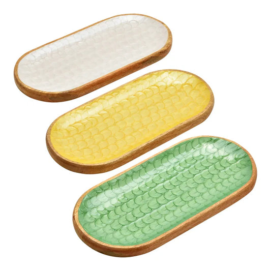 Three oval ceramic trays with wooden edges in white, yellow, and green on a white background