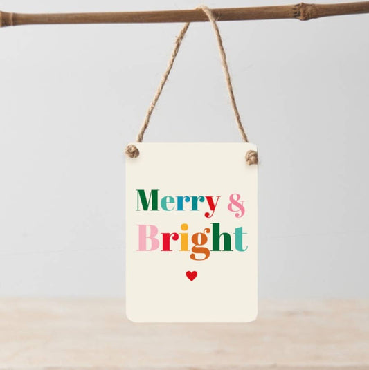 Decorative sign with 'Merry & Bright' text on a plain background
