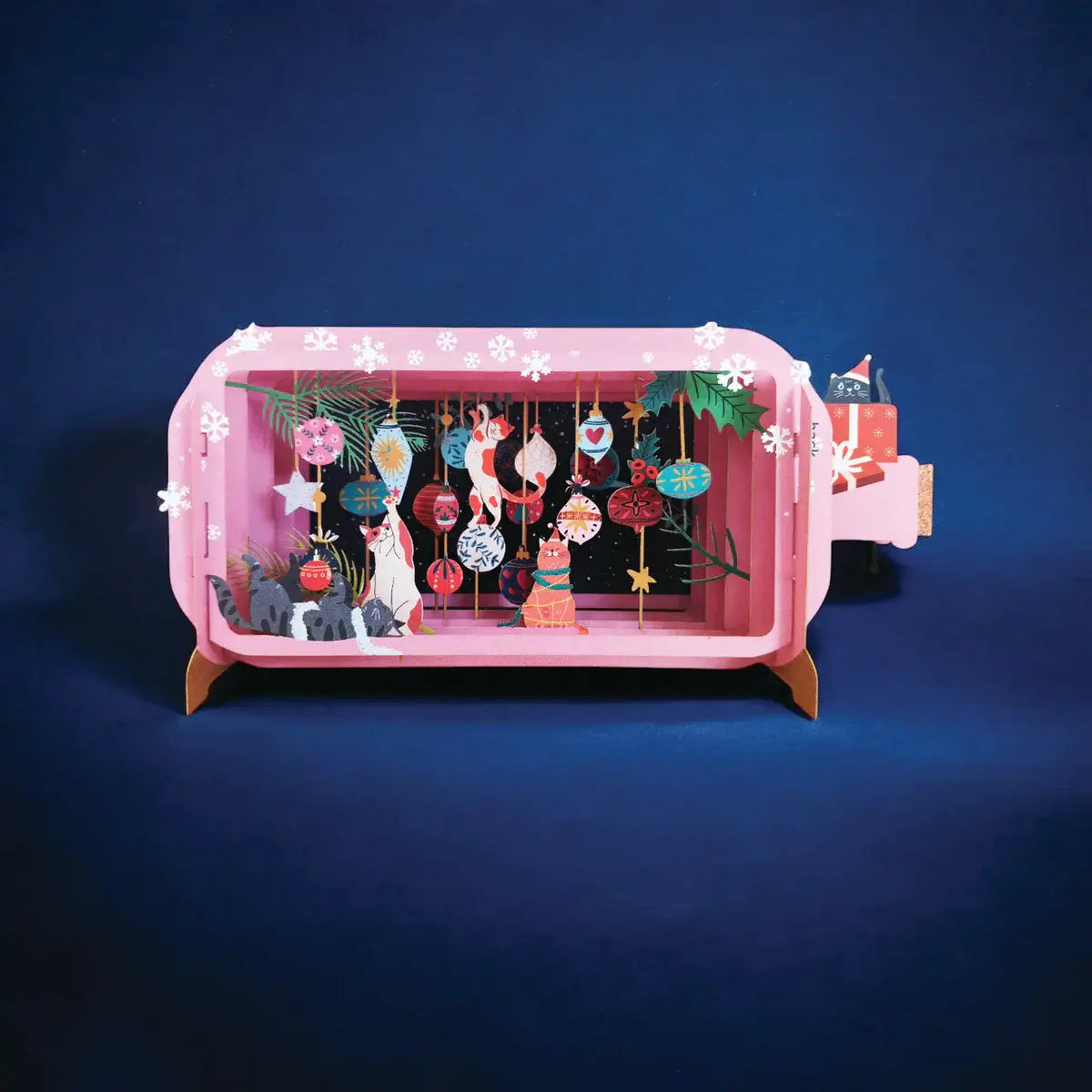Pink 3D card with Christmas decorations on a dark blue background