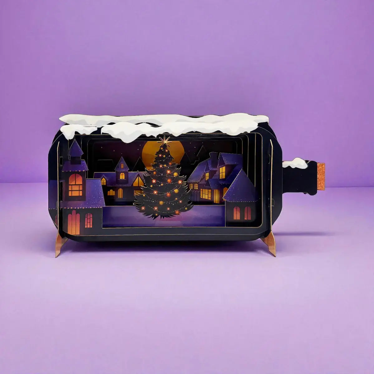 A Christmas tree in a night time townscape 3D card design on a purple background