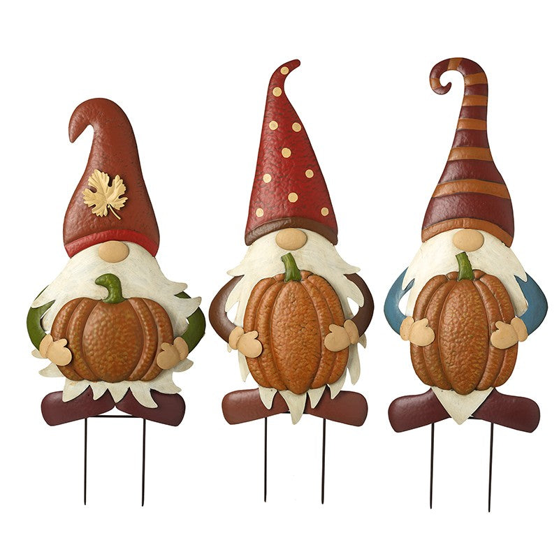 Three decorative gnomes with pumpkin decorations on a white background