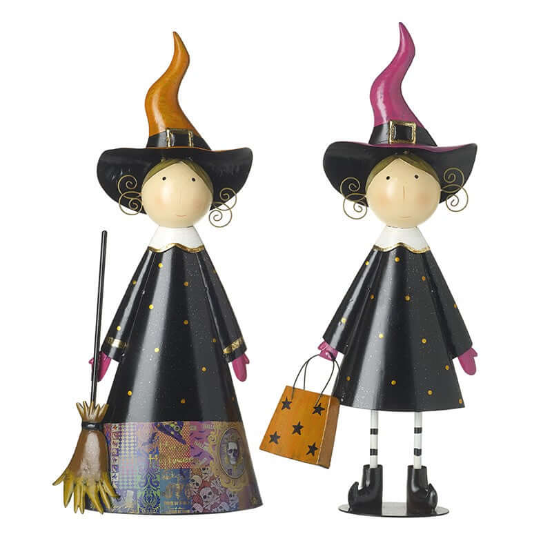 Two decorative witch figurines with colorful hats and brooms on a white background