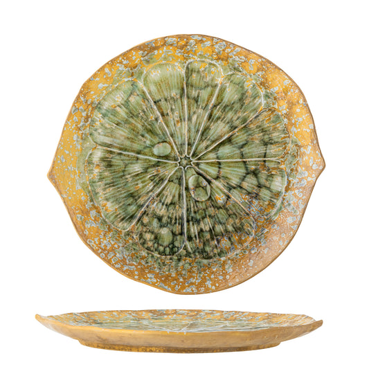 Decorative ceramic plate with green central design on a yellow background
