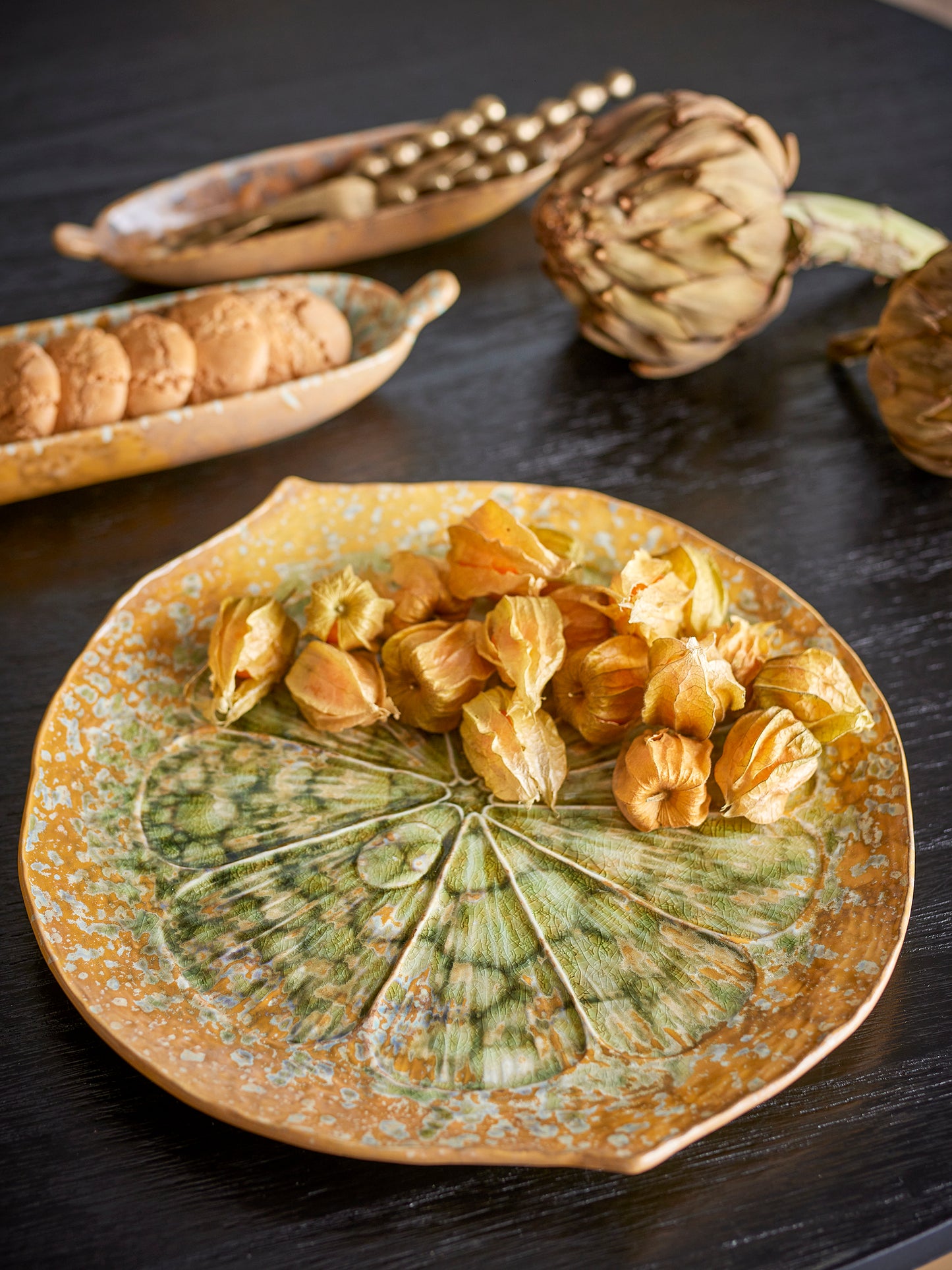 Decorative plate with dried fruits on a dark surface