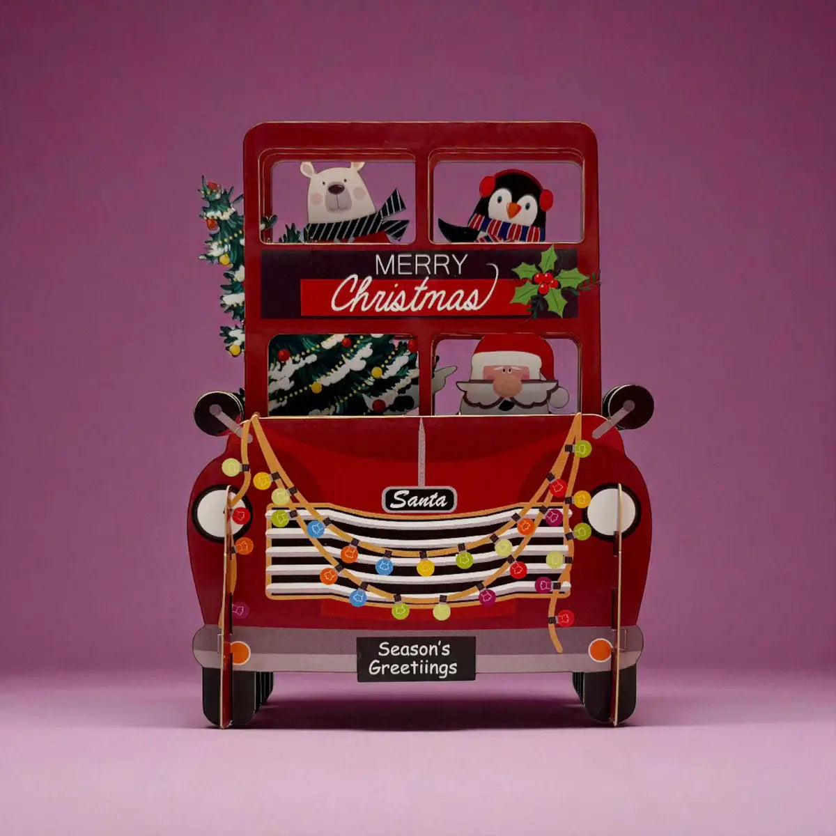 Red Christmas-themed car with Santa Claus and festive decorations on a pink background