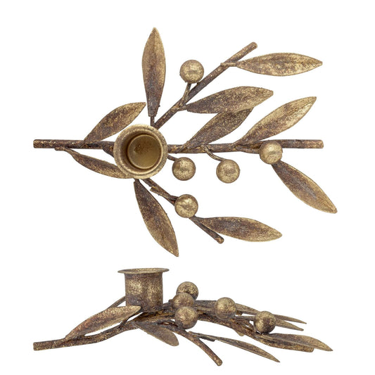 Decorative candle holder with leaf and berry design on a white background