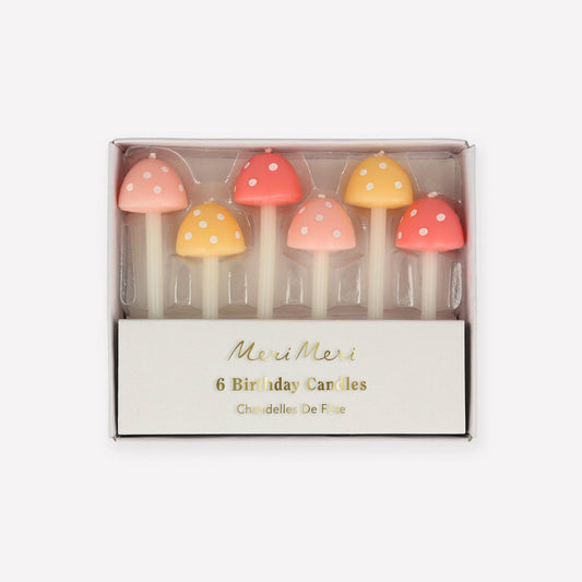 Set of six colorful mushroom-shaped birthday candles in a Meri Meri box on a white background