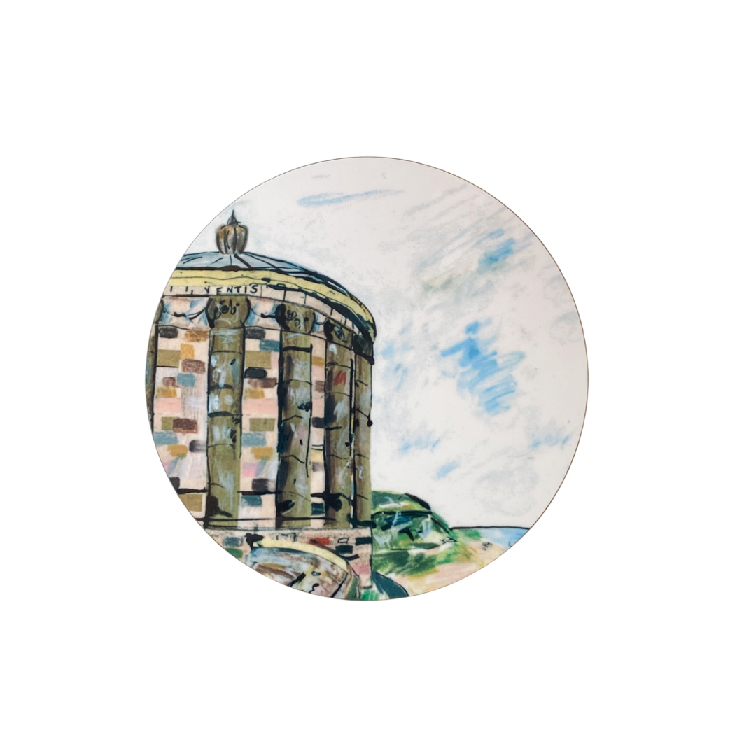 Round coaster with a scenic design of a building and landscape on a white background