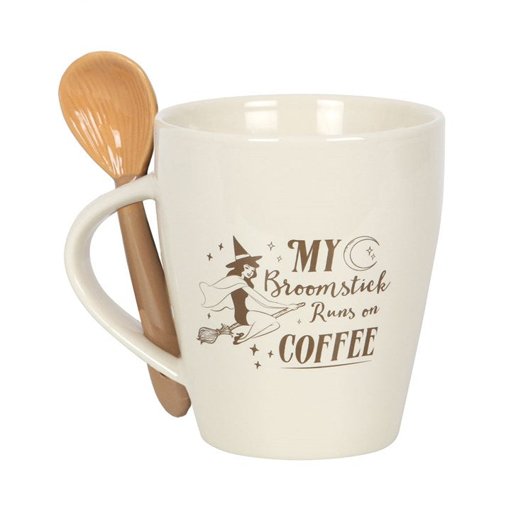 White mug with wooden spoon featuring a witch design and text on a white background