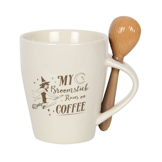 White mug with broomstick spoon featuring a humorous coffee-themed design on a white background