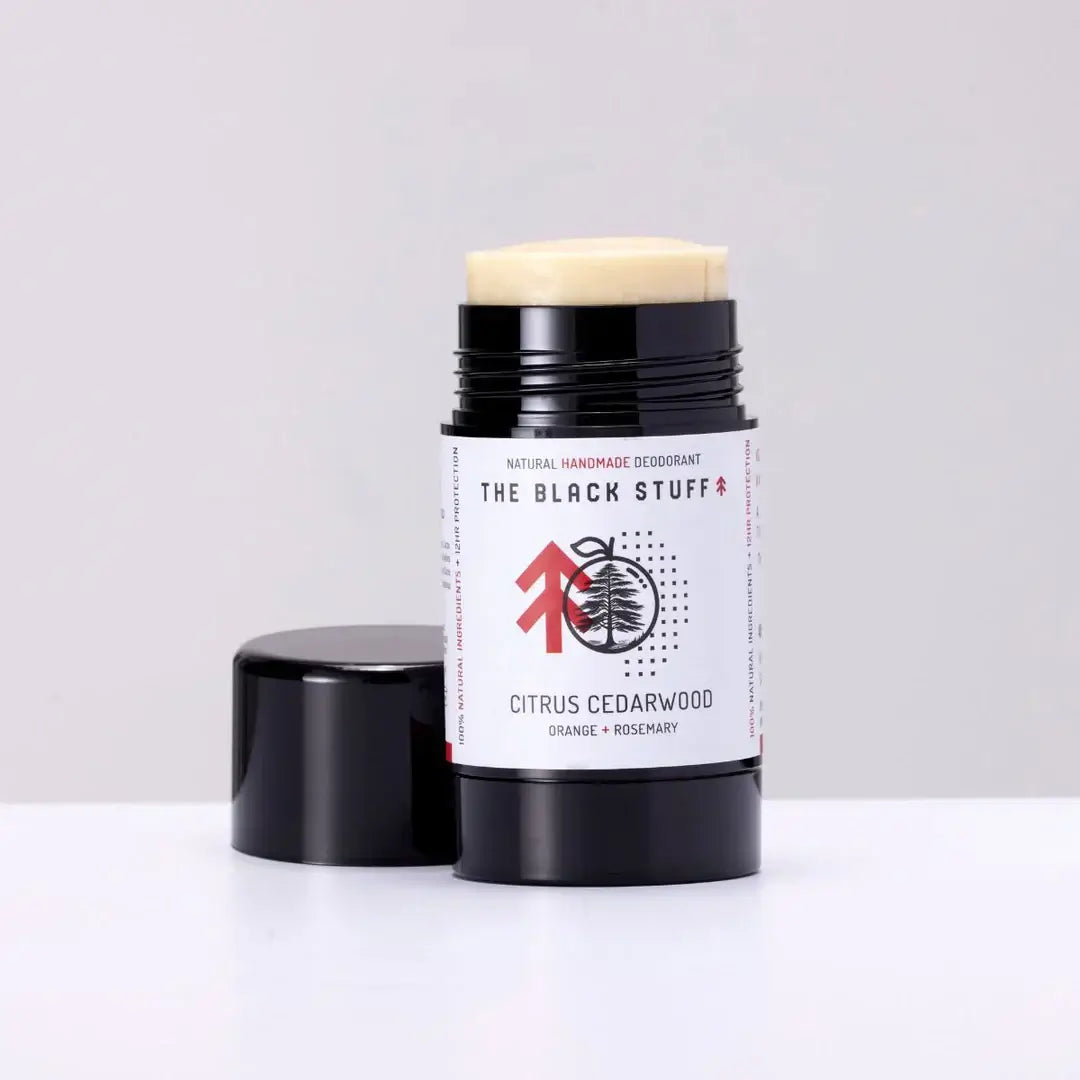 The Black Stuff Natural Deodorant - Citrus Cedarwood open container on a white background