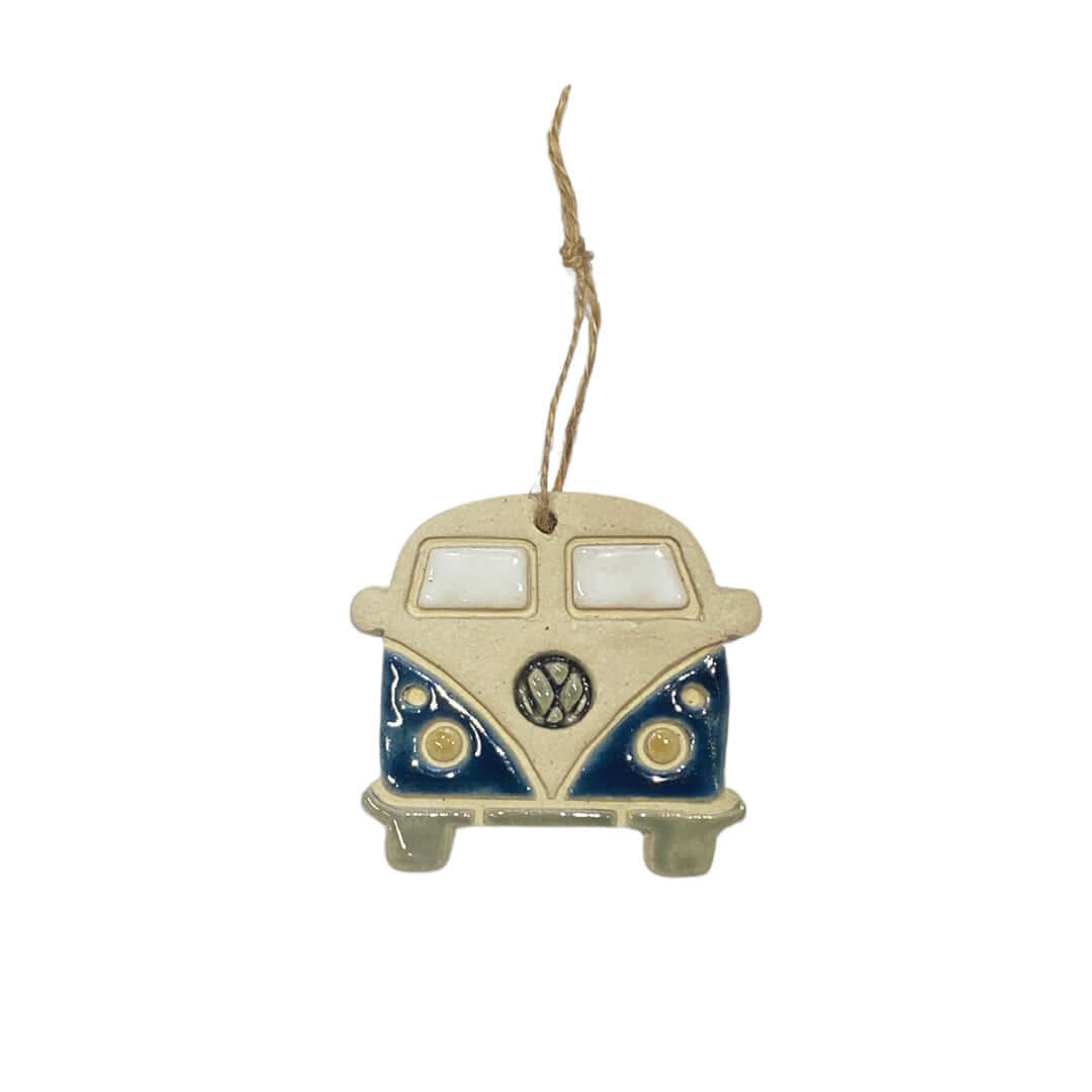 A ceramic decoration in the shape of a retro VW camper van, hanging from a string.