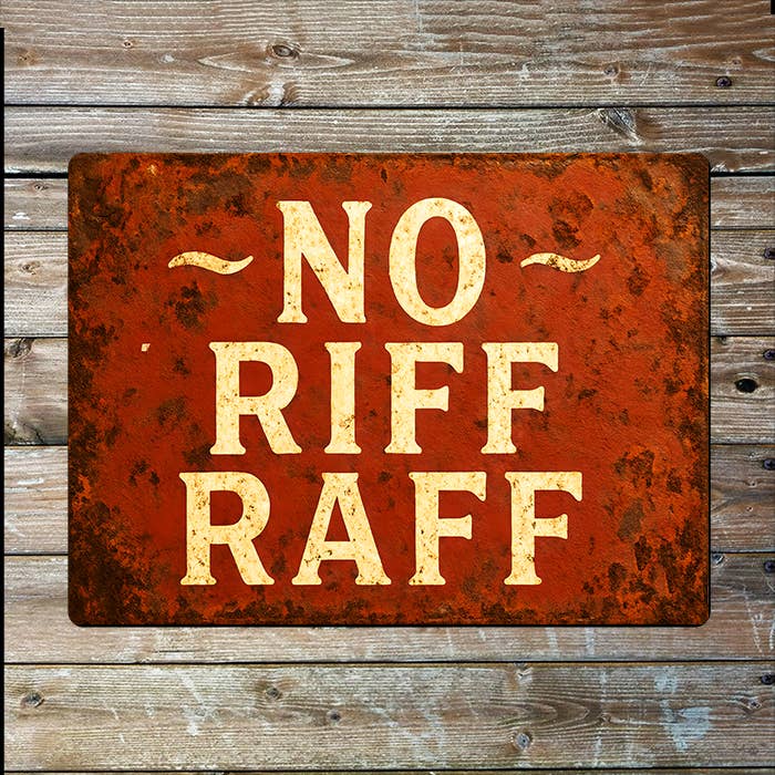 Rust-colored sign with 'NO RIFF RAFF' text on a wooden background