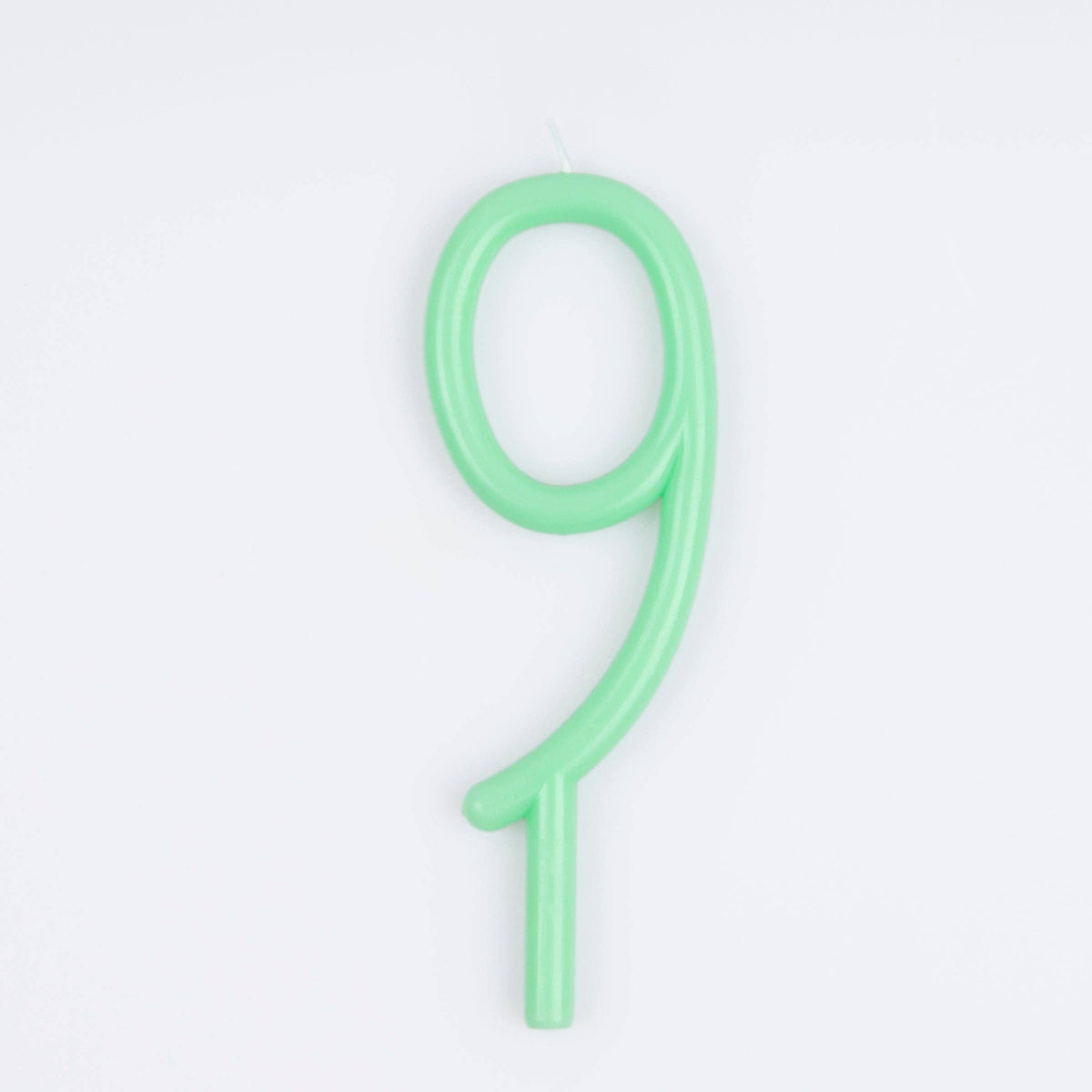 A single pale green birthday candle shaped like the number nine, shown on a clean white background.