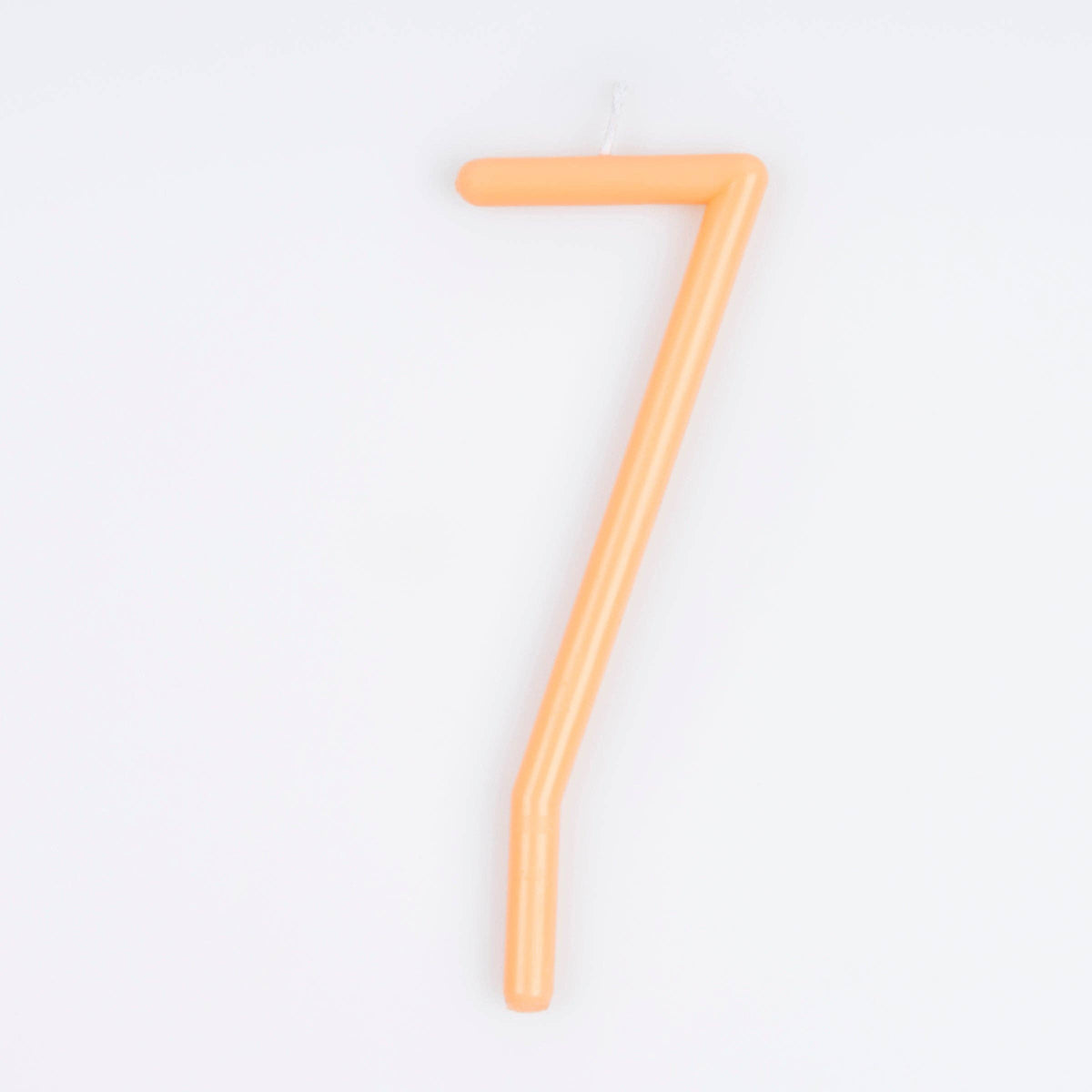A single peace birthday candle shaped like the number seven, shown on a clean white background.