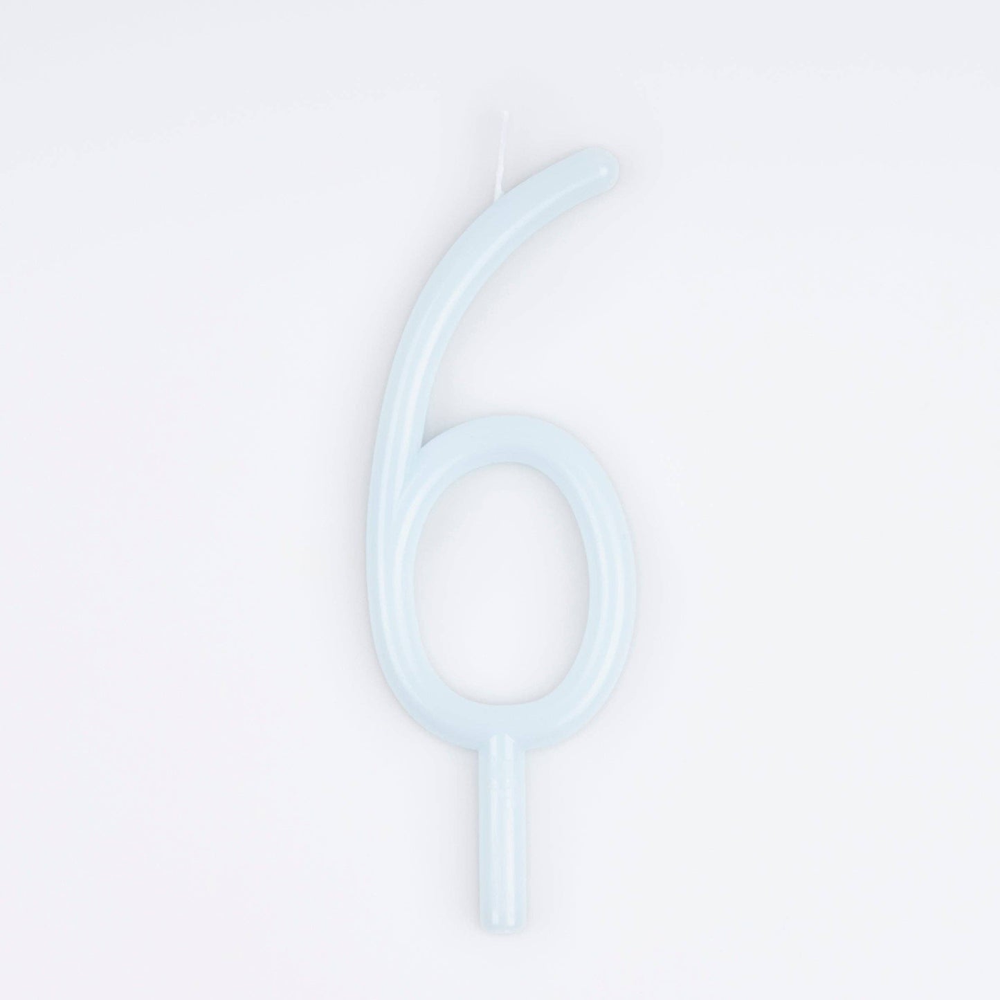 A single pale icy blue birthday candle shaped like the number six, shown on a clean white background.