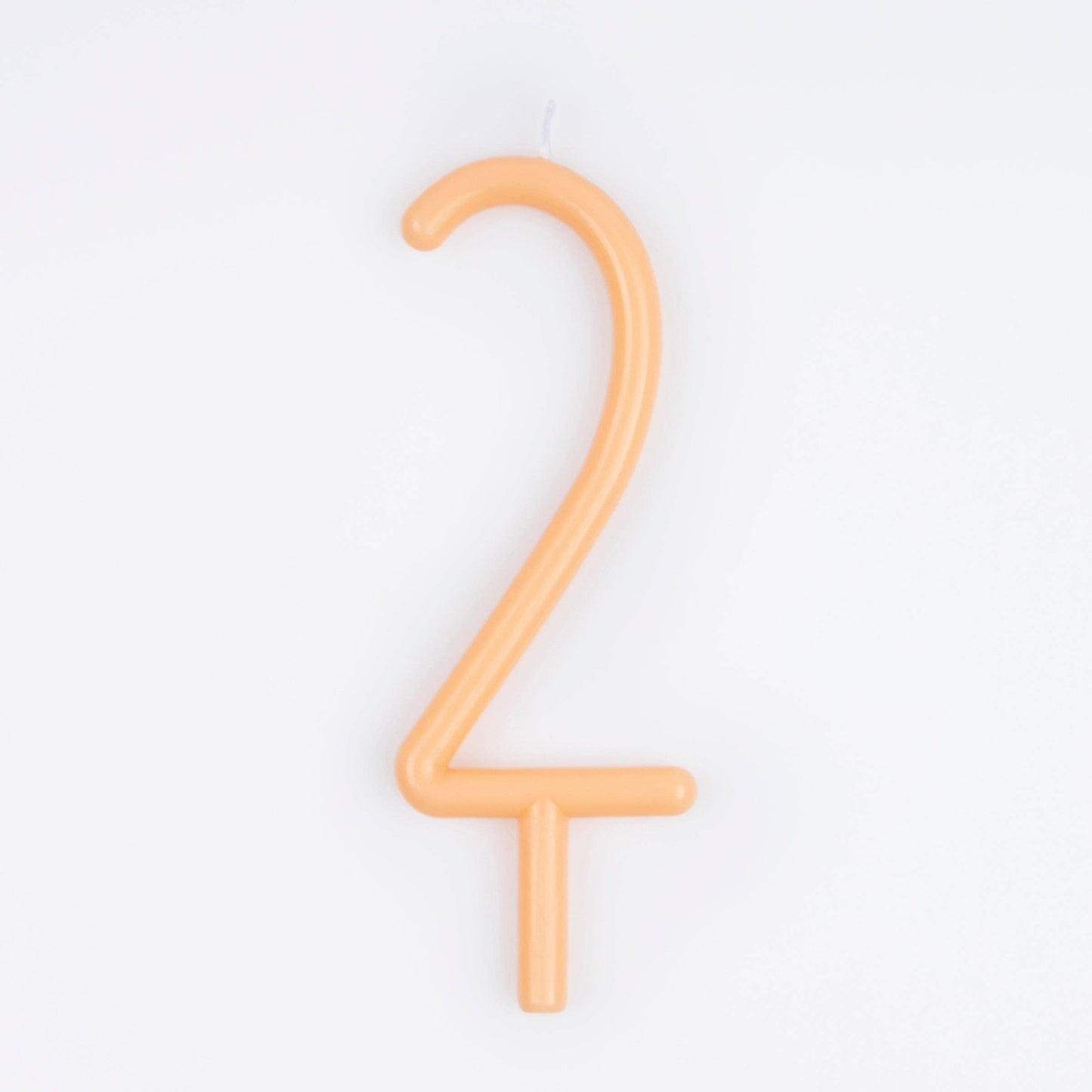 An orange wax number 2 birthday candle on a plain white background.
