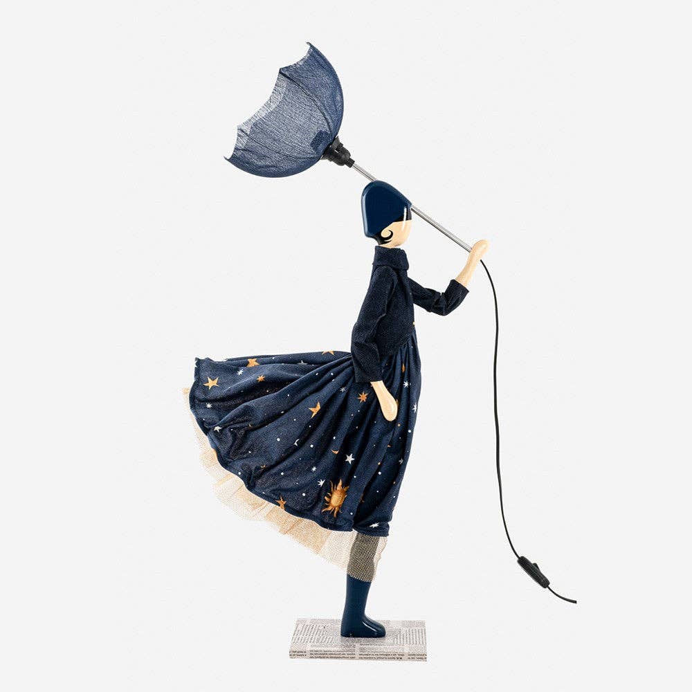 Decorative lamp as a figure of a lady in a dark blue outfit with a umbrella lampshade on a white background